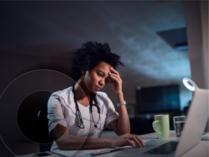 Tired medical professional looking at laptop